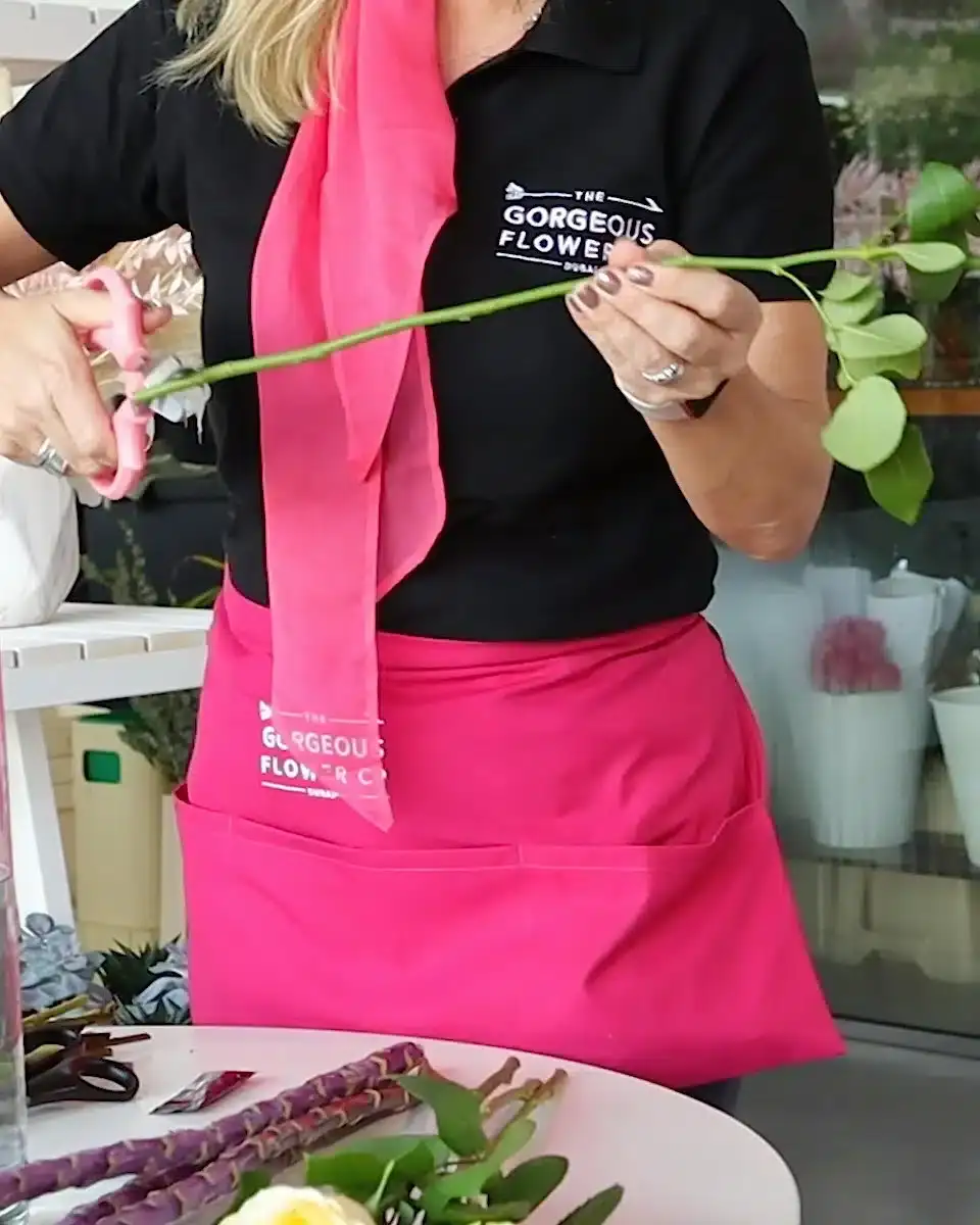 Sam cutting stems off a flower